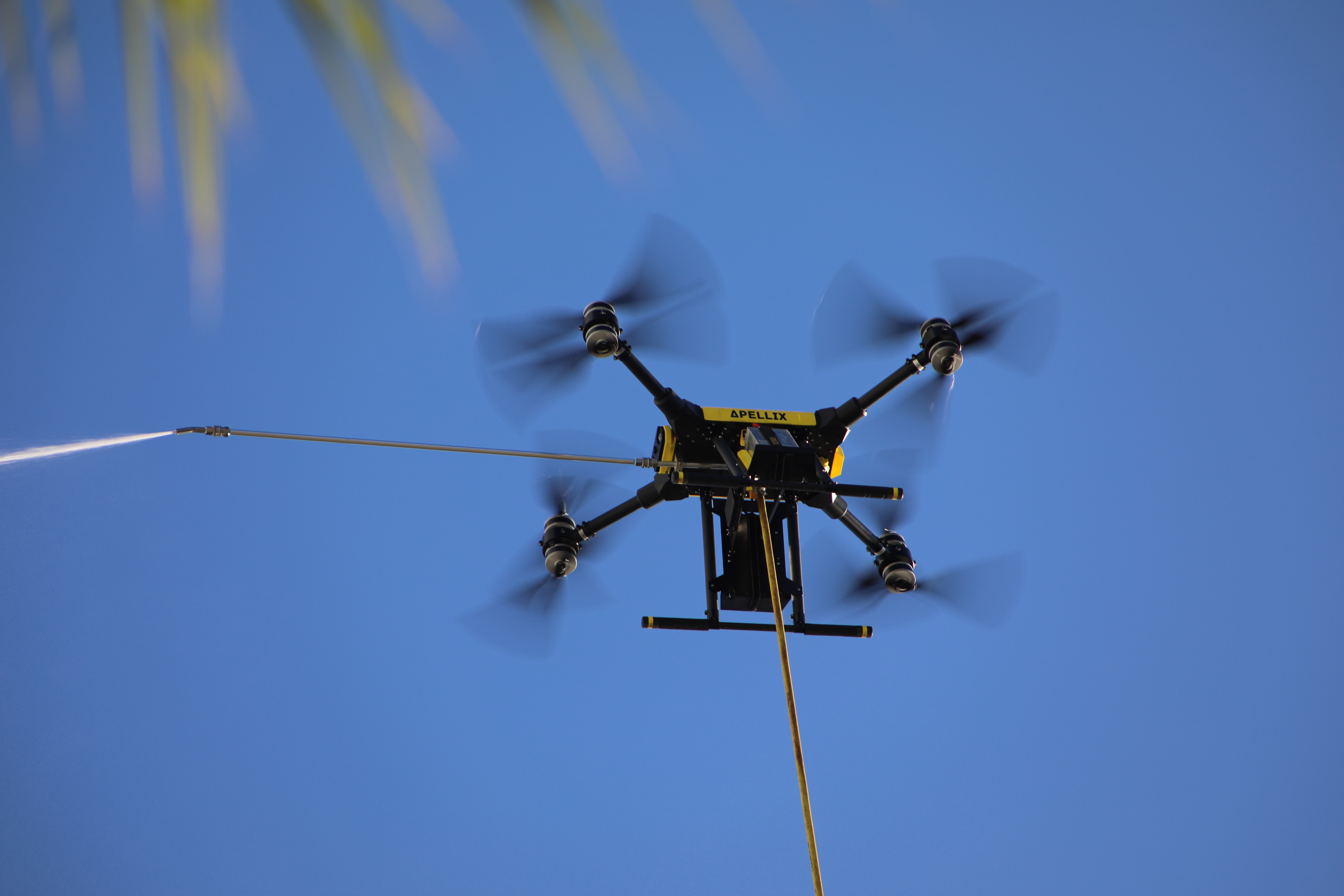 Apellix branded drone spraying in flight